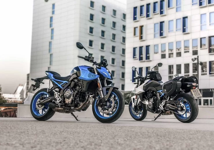 Lifestylefoto van een blauwe en witte 2023 Suzuki GSX 8S met op de achtergrond een wit gebouw