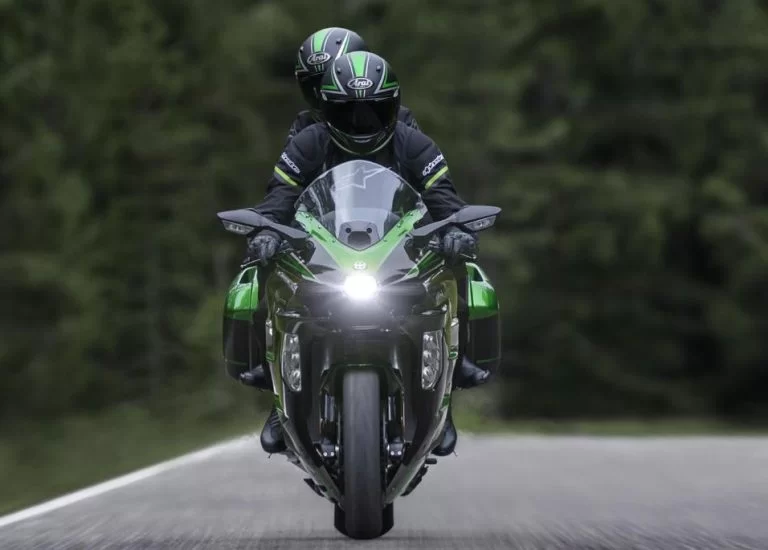 Kawasaki motor met rijder en bijrijder op de weg